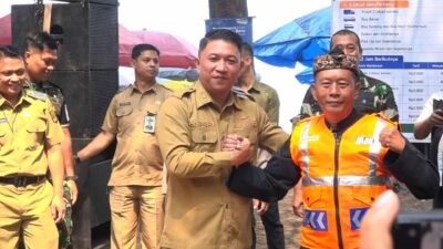 Wabup Sukabumi Andreas secara simbolis menyerahkan rompi bagi petugas parkir di wisata pantai. | Foto: I Nugraha